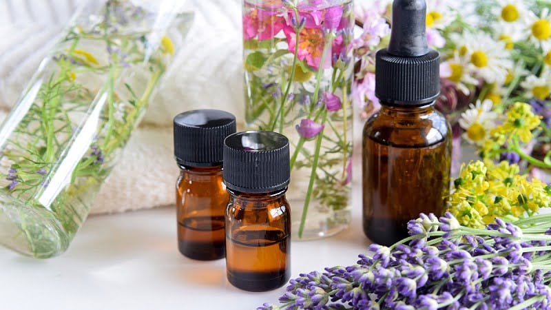 Terpenes oil in bottles and flowers on the side and in bottles 